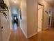 Long hallway featuring laminate floors, leading to the main entrance and bedrooms at 3828 6Th W Ave, Palmetto, FL 34221