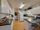 Bright eat-in kitchen with white cabinets, a breakfast bar, and laminate wood floors at 3828 6Th W Ave, Palmetto, FL 34221