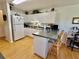 Bright eat-in kitchen with white cabinets and laminate wood floors at 3828 6Th W Ave, Palmetto, FL 34221