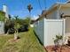 Side yard with a white fence, mature landscaping, and well-maintained lawn at 3828 6Th W Ave, Palmetto, FL 34221