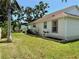 Landscaped side yard featuring well-maintained lawn and garden beds at 3828 6Th W Ave, Palmetto, FL 34221