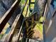 View of rustic wooden ladder leading up to a treehouse platform nestled in a large tree on a grassy lawn at 3828 6Th W Ave, Palmetto, FL 34221