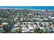 Aerial view of waterfront homes with lush landscaping and private pools, near the beach in a coastal community at 385 Avenida Madera, Sarasota, FL 34242