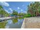 Scenic view of the backyard and canal, enhanced by vibrant greenery and ample space for outdoor enjoyment at 385 Avenida Madera, Sarasota, FL 34242