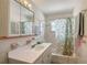Well-maintained bathroom with decorative shower curtain, vanity with sink, and a mirrored medicine cabinet at 385 Avenida Madera, Sarasota, FL 34242