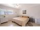 Cozy bedroom with ceiling fan, neutral decor, and natural light, creating a tranquil atmosphere at 385 Avenida Madera, Sarasota, FL 34242
