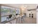 Bright dining area featuring tile floors, access to the screened-in patio, and modern furnishings at 385 Avenida Madera, Sarasota, FL 34242