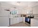 Well-lit kitchen featuring modern appliances, white cabinetry, and durable countertops at 385 Avenida Madera, Sarasota, FL 34242