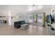 Bright living room with large window, modern sofa, stylish coffee table, and tile floors at 385 Avenida Madera, Sarasota, FL 34242