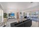 Bright living room with neutral tones, cozy seating, and seamless access to the outdoor patio at 385 Avenida Madera, Sarasota, FL 34242