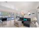 Bright living room featuring a modern sofa, stylish coffee table, and sliding glass doors to the outdoor area at 385 Avenida Madera, Sarasota, FL 34242