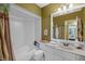 Bright bathroom featuring a tub and shower combination and a marble countertop vanity at 4109 Carriage Dr # 23, Sarasota, FL 34241