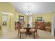 Bright dining area with tile flooring, a chandelier, and decorative furnishings at 4109 Carriage Dr # 23, Sarasota, FL 34241