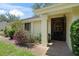 Front entrance features a decorative security door and mature landscaping around the walkway at 4109 Carriage Dr # 23, Sarasota, FL 34241