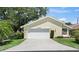 Inviting single-story home featuring an attached two-car garage and concrete driveway at 4109 Carriage Dr # 23, Sarasota, FL 34241