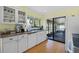 The bright kitchen offers white cabinets and opens to the outdoor patio through sliding glass doors at 4109 Carriage Dr # 23, Sarasota, FL 34241