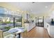 Eat-in kitchen features a marble table set by the window with views of the front yard and white cabinetry at 4109 Carriage Dr # 23, Sarasota, FL 34241