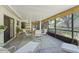 Spacious enclosed lanai with dining and lounge seating, screened windows and neutral decor at 4109 Carriage Dr # 23, Sarasota, FL 34241