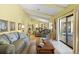 Spacious living room with high ceilings, comfortable seating, and access to the back patio with lots of natural light at 4109 Carriage Dr # 23, Sarasota, FL 34241