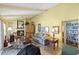 Traditional living room featuring high ceilings, a fireplace, comfortable furniture, and access to a charming library at 4109 Carriage Dr # 23, Sarasota, FL 34241