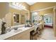 Spacious main bathroom features vanity, large mirror, and views into the main bedroom and walk-in closet at 4109 Carriage Dr # 23, Sarasota, FL 34241