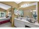 Bright main bathroom features vanity, large mirror, and views into the main bedroom and walk-in closet at 4109 Carriage Dr # 23, Sarasota, FL 34241
