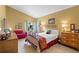 Cozy main bedroom features tiled floors, vaulted ceiling, with views to the outside yard, and access to the en-suite at 4109 Carriage Dr # 23, Sarasota, FL 34241