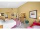 Warm main bedroom with tiled floors, vaulted ceilings, and views into the main bathroom and walk-in closet at 4109 Carriage Dr # 23, Sarasota, FL 34241