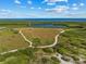 Stunning aerial view of a park with walking trails, a lake, and diverse natural landscapes meeting the ocean at 4204 Overture Cir # 4204, Bradenton, FL 34209