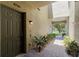 View of the front door to unit 4204 and its brick-paved walkway and colorful landscaping at 4204 Overture Cir # 4204, Bradenton, FL 34209