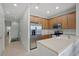 Charming kitchen features stainless steel appliances, granite countertops, and wood cabinets with a staircase down the hall at 4204 Overture Cir # 4204, Bradenton, FL 34209