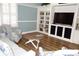 Comfortable seating area featuring built-in shelving, a TV, and a round coffee table in a sunlit space at 4204 Overture Cir # 4204, Bradenton, FL 34209