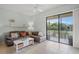 Living room with a view of the screened-in outdoor patio and the lake at 4204 Overture Cir # 4204, Bradenton, FL 34209
