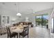 View of the dining and living areas with access to the screened-in patio overlooking the lake at 4204 Overture Cir # 4204, Bradenton, FL 34209