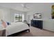 Bright main bedroom featuring a large window, dark wood dresser, and neutral carpeting at 4204 Overture Cir # 4204, Bradenton, FL 34209