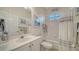 Well-lit bathroom with vanity, tub, and shower at 4220 Miriana Way, Sarasota, FL 34233