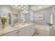 Bathroom with double sink vanity, soaking tub and natural light at 4220 Miriana Way, Sarasota, FL 34233