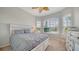 Neutral bedroom with bright light and wood fan at 4220 Miriana Way, Sarasota, FL 34233