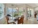 Bright breakfast nook with a glass table, wood chairs, and a lovely view of the outdoors at 4220 Miriana Way, Sarasota, FL 34233