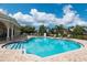Community pool features lounge chairs and lush landscaping for relaxation and recreation at 4220 Miriana Way, Sarasota, FL 34233