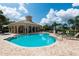 Community pool and spa, surrounded by lounge chairs and lush landscaping, offers residents relaxation and recreation at 4220 Miriana Way, Sarasota, FL 34233