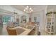 Dining room with modern chandelier, dinning table set and open floor plan to living room and bedroom at 4220 Miriana Way, Sarasota, FL 34233