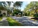 The gated entrance is adorned with plants and flowers and beautiful stonework at 4220 Miriana Way, Sarasota, FL 34233