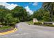 Entrance to the Villa Rosa community with stone signage and landscaping at 4220 Miriana Way, Sarasota, FL 34233
