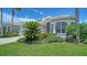 Beautifully landscaped front yard with lush green grass, shrubs and well-maintained exterior of the house at 4220 Miriana Way, Sarasota, FL 34233