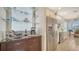 Bright kitchen with white cabinets, stainless steel appliances, granite countertops, and a nearby wine rack at 4220 Miriana Way, Sarasota, FL 34233