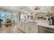 Modern kitchen featuring white cabinets, quartz countertops, stainless steel appliances, and breakfast nook view at 4220 Miriana Way, Sarasota, FL 34233