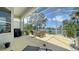 The screened lanai has a table and chairs, a grill and beautiful lake views at 4220 Miriana Way, Sarasota, FL 34233