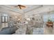 Bright living room with tile floors, elegant furniture, open floor plan to the dining area and kitchen at 4220 Miriana Way, Sarasota, FL 34233