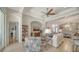Comfortable living room with a sofa, armchairs, decorative lamps, and elegant arched doorways to the dining area at 4220 Miriana Way, Sarasota, FL 34233